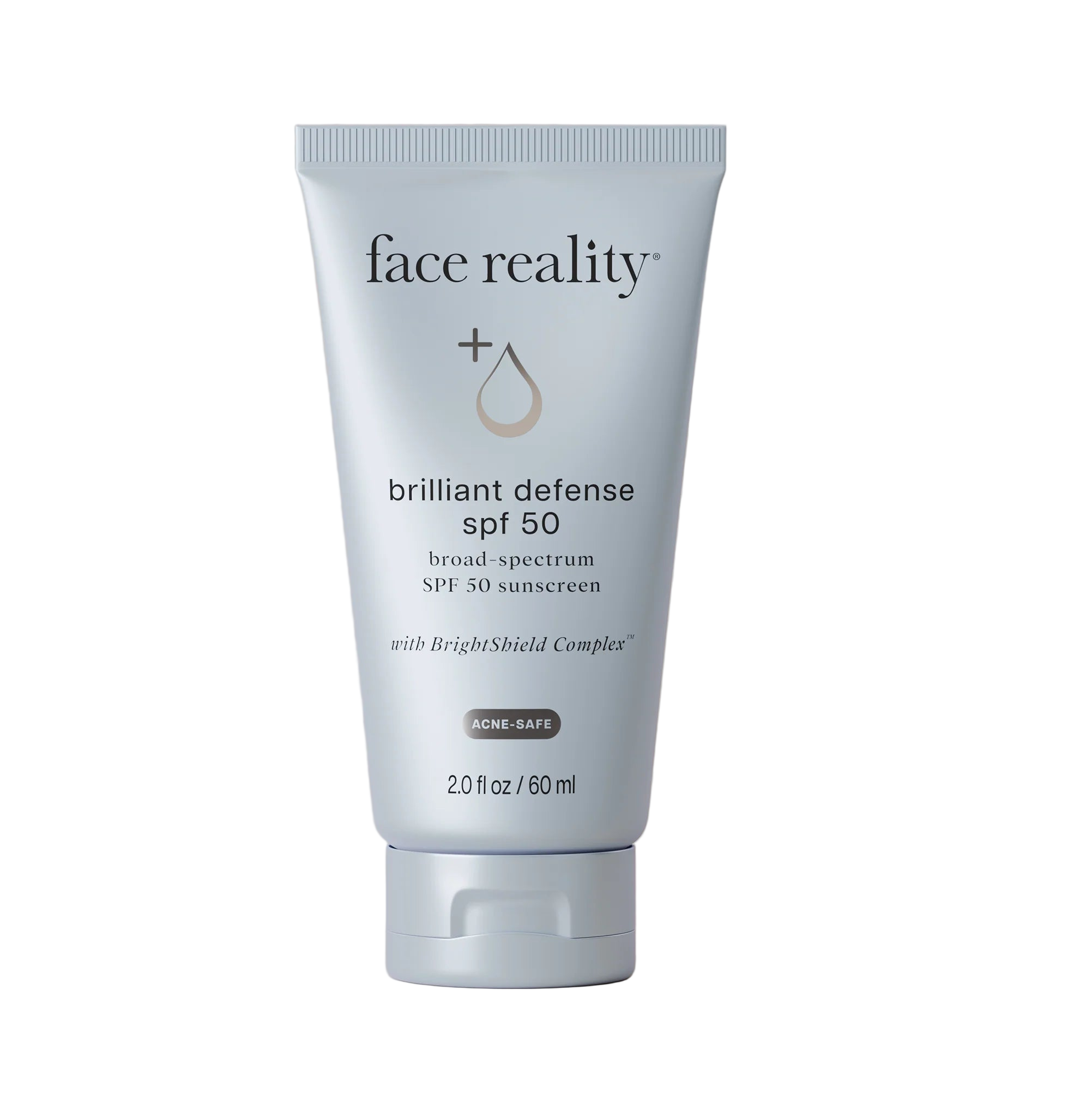 Tube of 'face reality' Brilliant Defense SPF 50 sunscreen on a beige background